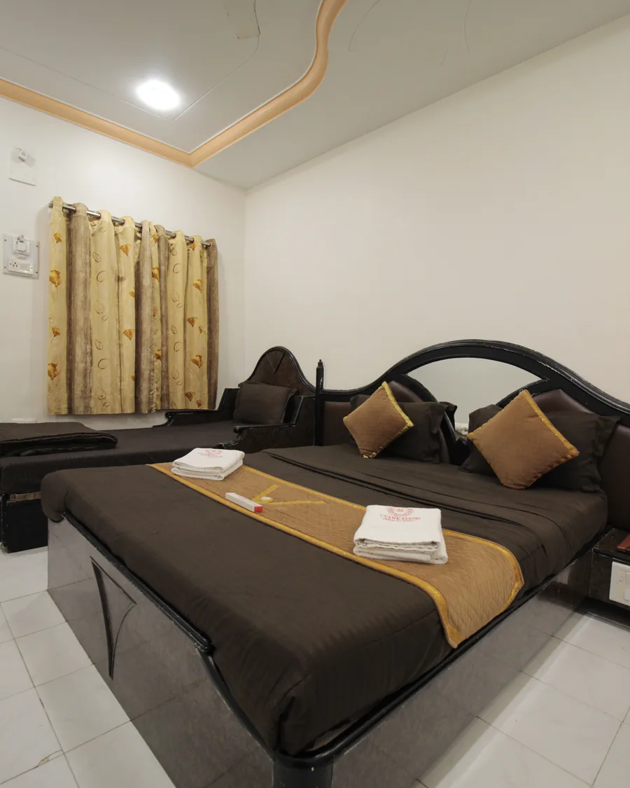 A warm, comfortable guest room at Hotel Vyankatesh — a quiet retreat in the heart of Mahabaleshwar's market
